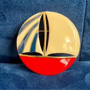 Vintage red, white and blue brooch. Round, in the shape of a sailboat